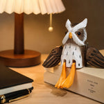 Cargar imagen en el visor de la Galería, Hand-carved wooden hanging-leg owl ornament styled on a tabletop edge