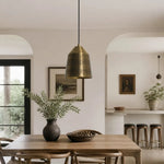 Load image into Gallery viewer, Brass pendant lamp installed above a dining space