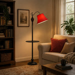 Load image into Gallery viewer, Burgundy fabric shade floor lamp glowing beside a sofa and coffee table