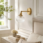 Cargar imagen en el visor de la Galería, Antique brass ribbed glass wall sconce installed beside a bed