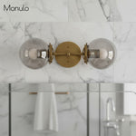 Cargar imagen en el visor de la Galería, Lámpara de tocador de baño moderna de estilo industrial Lumio Globe de cristal transparente