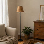Bild in Gallery-Viewer laden, Rattan shade floor lamp in a warm bedroom corner