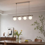 Load image into Gallery viewer, White globe chandelier above a dining table