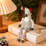 Cargar imagen en el visor de la Galería, Hand-carved wooden zebra with santa hat ornament styled on a tabletop edge