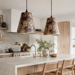 Cargar imagen en el visor de la Galería, Pair of patina iron pendant lamps above a kitchen island