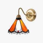 Load image into Gallery viewer, Orange stained glass wall sconce with antique brass-tone arm