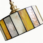 Cargar imagen en el visor de la Galería, Close view of the stained glass pendant shade with brass socket and textured panels