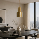 Load image into Gallery viewer, Vintage brass pendant lamp above a modern dining table