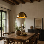 Bild in Gallery-Viewer laden, Brass dome pendant light in a dining room with wood furniture