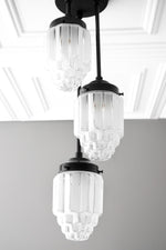 Load image into Gallery viewer, Tierlux Glass Tiered Skyscraper Shade Pendant – Art Deco Ceiling Light for Kitchen Island
