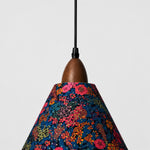 Bild in Gallery-Viewer laden, Close-up of walnut-tone wood holder and dark botanical Liberty fabric