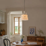 Bild in Gallery-Viewer laden, Ceramic bow pendant light in a softly lit dining space