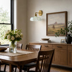 Cargar imagen en el visor de la Galería, Blue milk glass brass wall sconce in a dining room
