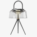 Load image into Gallery viewer, Clear solar garden lantern with black handle and tripod legs