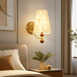 Bild in Gallery-Viewer laden, Capiz shell wall sconce installed beside a softly upholstered bed