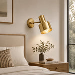 Bild in Gallery-Viewer laden, Adjustable brass wall sconce above a wood nightstand