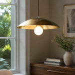 Load image into Gallery viewer, Brushed brass-finish dome pendant light beside a bright window