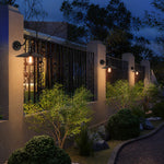 Load image into Gallery viewer, Outdoor wall sconce along a garden path