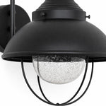 Bild in Gallery-Viewer laden, Seeded-glass globe beneath a black metal shade and cage