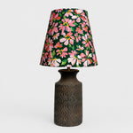 Cargar imagen en el visor de la Galería, Front view of floral fabric table lamp with textured dark ceramic base