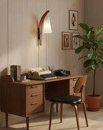 Cargar imagen en el visor de la Galería, Curved walnut and frosted glass plug-in wall lamp on a wood wall