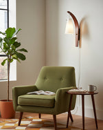 Cargar imagen en el visor de la Galería, Curved walnut and frosted glass plug-in wall lamp in a reading corner
