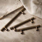 Cargar imagen en el visor de la Galería, Antique brass cabinet pulls grouped on stone surface