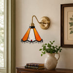 Load image into Gallery viewer, Orange stained glass wall sconce on a framed art wall