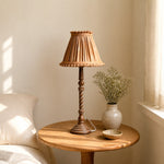 Load image into Gallery viewer, Warm tan pleated table lamp beside window in soft home corner