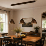 Cargar imagen en el visor de la Galería, Three hammered copper pendant lights in a warm dining room