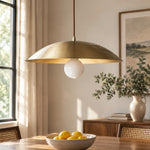 Load image into Gallery viewer, Brushed brass-finish dome pendant light above a dining table