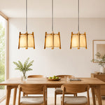Cargar imagen en el visor de la Galería, Natural wood fabric pendant lights in a bright dining room