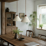 Load image into Gallery viewer, Pair of natural paper pendant lamps over a wood dining table