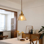 Cargar imagen en el visor de la Galería, Amber glass pendant above a kitchen table