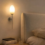Cargar imagen en el visor de la Galería, Milk glass wall sconce beside an upholstered bed