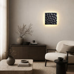 Bild in Gallery-Viewer laden, Square travertine wall sconce used as bedside ambient lighting