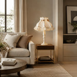 Load image into Gallery viewer, Ivory lace table lamp beside a sofa and window