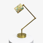Load image into Gallery viewer, Adjustable brass-tone table lamp with cream garden floral fabric shade