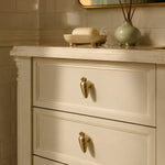 Cargar imagen en el visor de la Galería, Brass rabbit and carrot cabinet knobs on a cream dresser