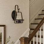 Load image into Gallery viewer, Clear glass wall sconce installed by stair rail