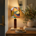 Load image into Gallery viewer, Colorful printed fabric table lamp in a styled interior