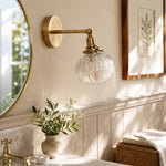 Cargar imagen en el visor de la Galería, Antique brass ribbed glass sconce beside a mirror