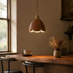 Load image into Gallery viewer, Brown leather petal pendant light above a warm desk corner