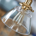 Cargar imagen en el visor de la Galería, Close view of brass socket and clear glass shade