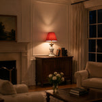 Bild in Gallery-Viewer laden, Red bedside table lamp glowing in an evening room