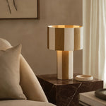 Cargar imagen en el visor de la Galería, Apricot striped table lamp lit on a marble side table beside a sofa