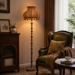 Bild in Gallery-Viewer laden, Blue orange check floor lamp glowing beside a leather reading chair