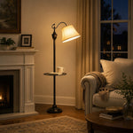 Load image into Gallery viewer, Beige shade floor lamp glowing in a classic living room near a fireplace