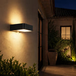 Cargar imagen en el visor de la Galería, Style A outdoor wall lamp casting warm light on an exterior wall