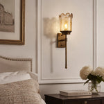 Load image into Gallery viewer, Brass amber glass wall sconce styled beside a bed